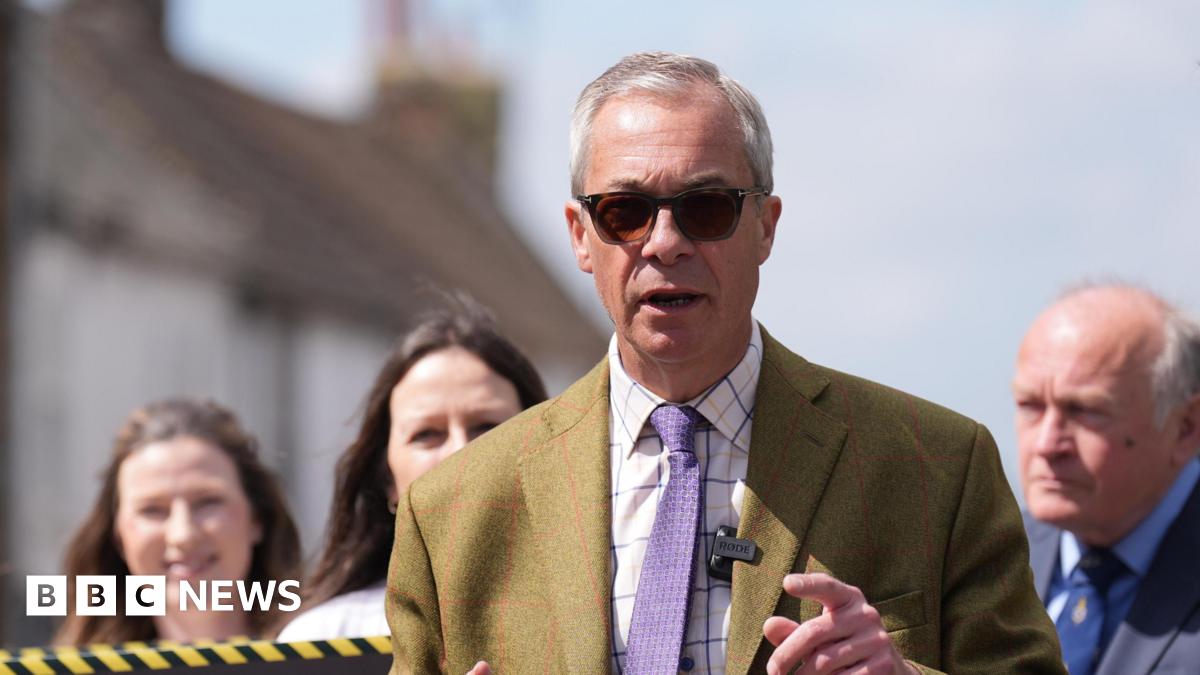Nigel Farage in dark glasses and a mustard coloured suit on a walkabout