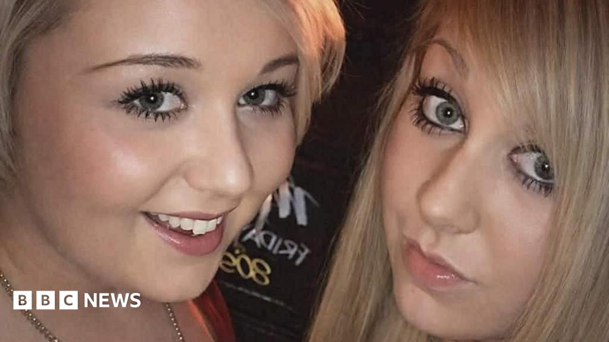 A selfie photo of two blonde girls. They are both wearing lots of make up and smiling at the camera.