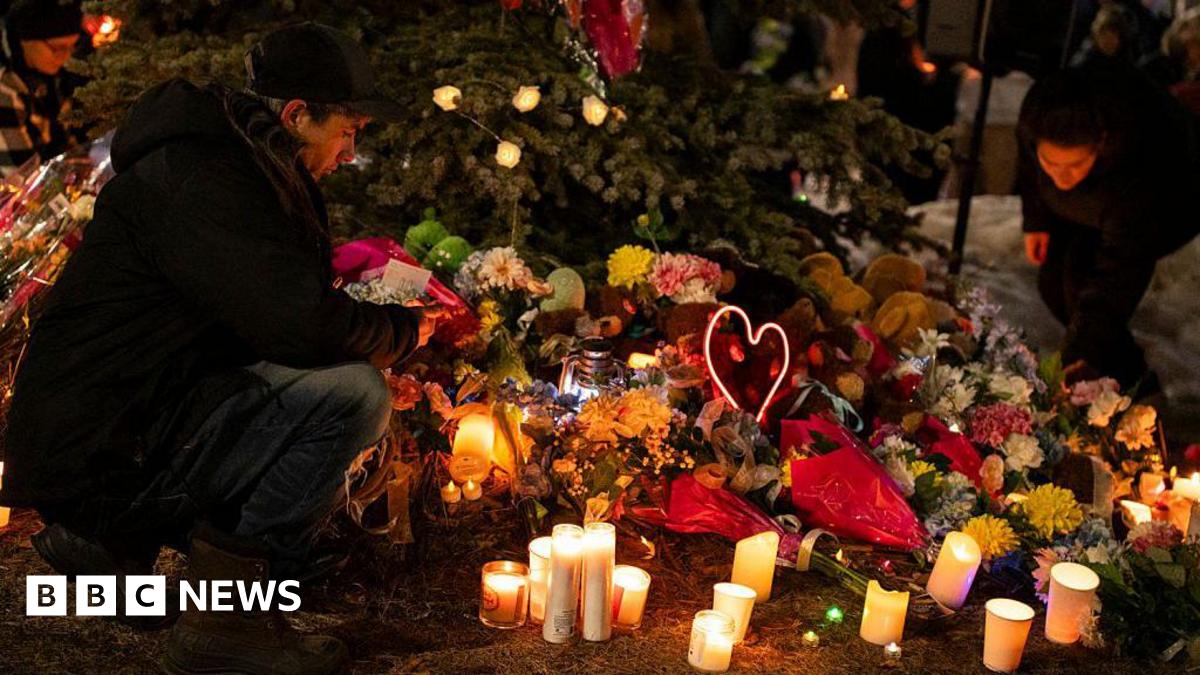 A memorial of candles and flowers are laid at a vigil for victims of a shooting at Tumbler Ridge Secondary School in British Columbia, Canada. 