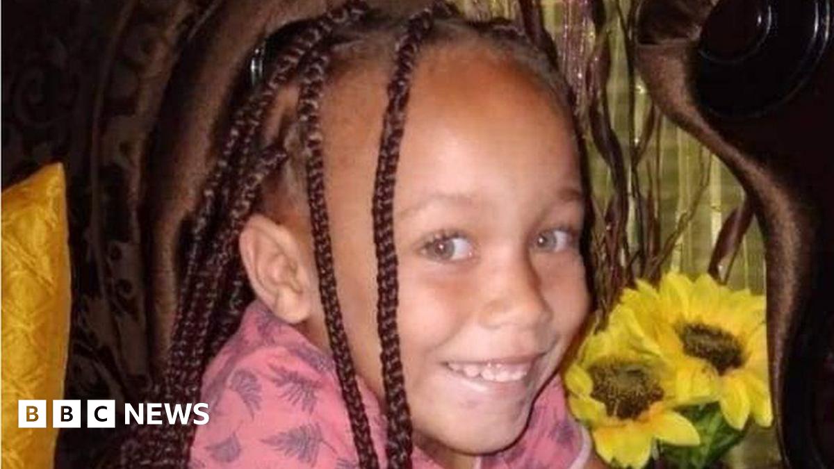Joshlin Smith, with her hair in plaits and wearing a pink top, smiles at the camera
