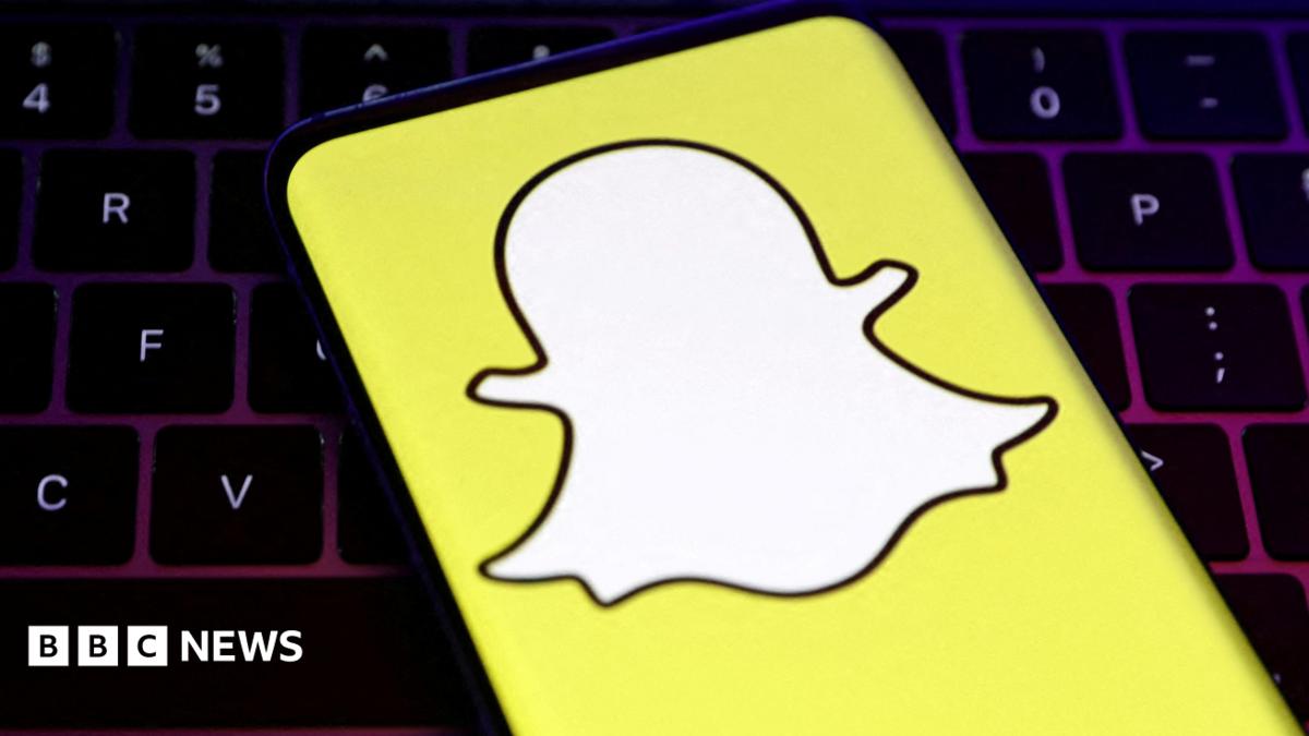 Photo: bbc.co.uk A closeup of Snapchat's logo, a white cartoon ghost with a bright yellow background, held over a laptop conputer keyboard