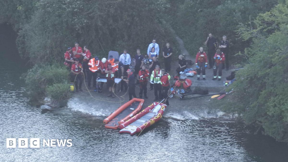 Search and rescue teams at the side of a pond