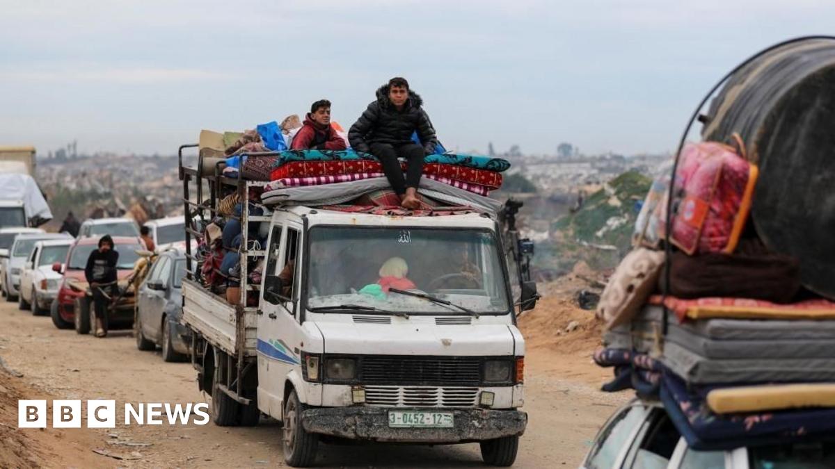 Palestinians wait to cross through a checkpoint run by US and Egyptian security contractors after Israeli forces withdrew from the Netzarim Corridor near Gaza City, 9 February 2025