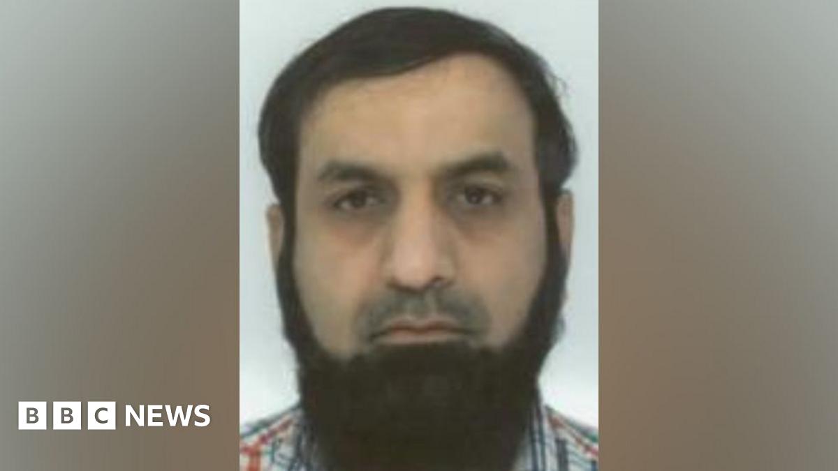Mohammad Siddiqui mugshot - He has brown combed-over hair and a long brown beard.