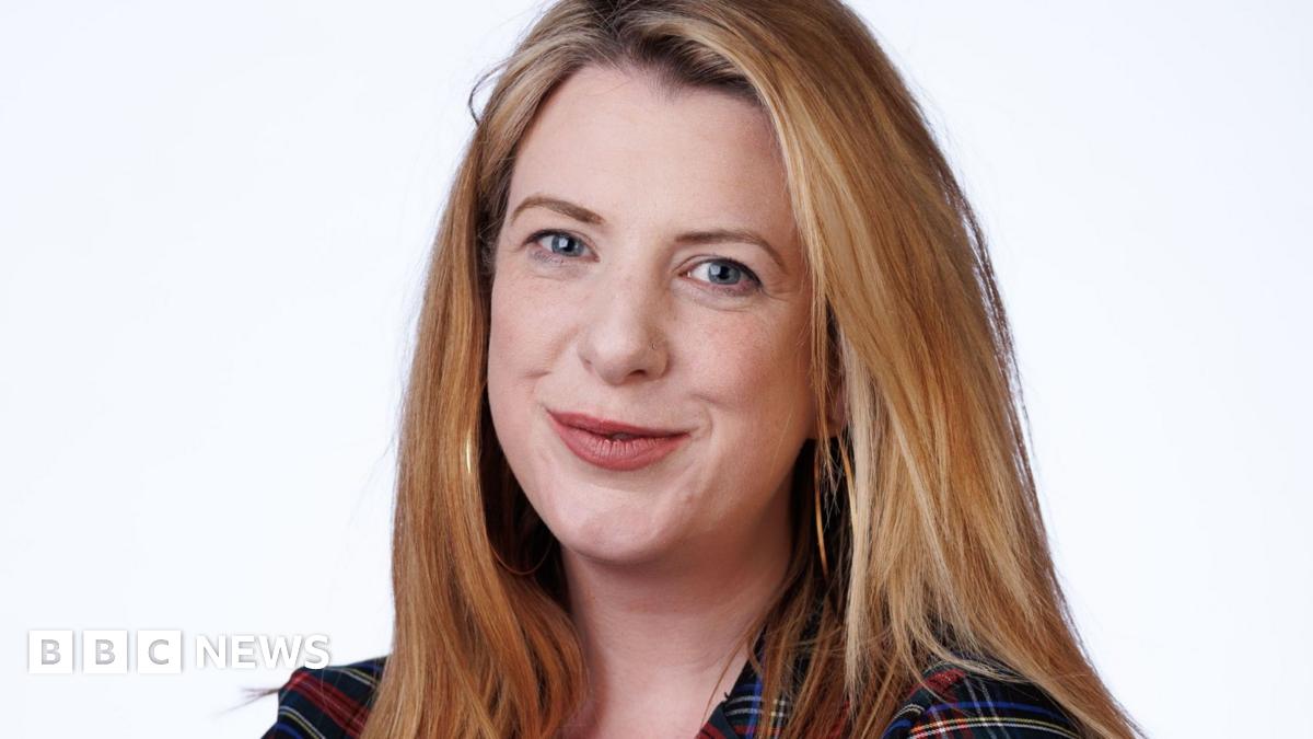 A head and shoulders shot of a smiling Nicky Brennan, who has fair hair