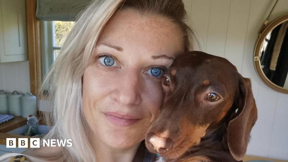 Hattie Wilderman is holding her beloved sausage dog Bertie who died last November 