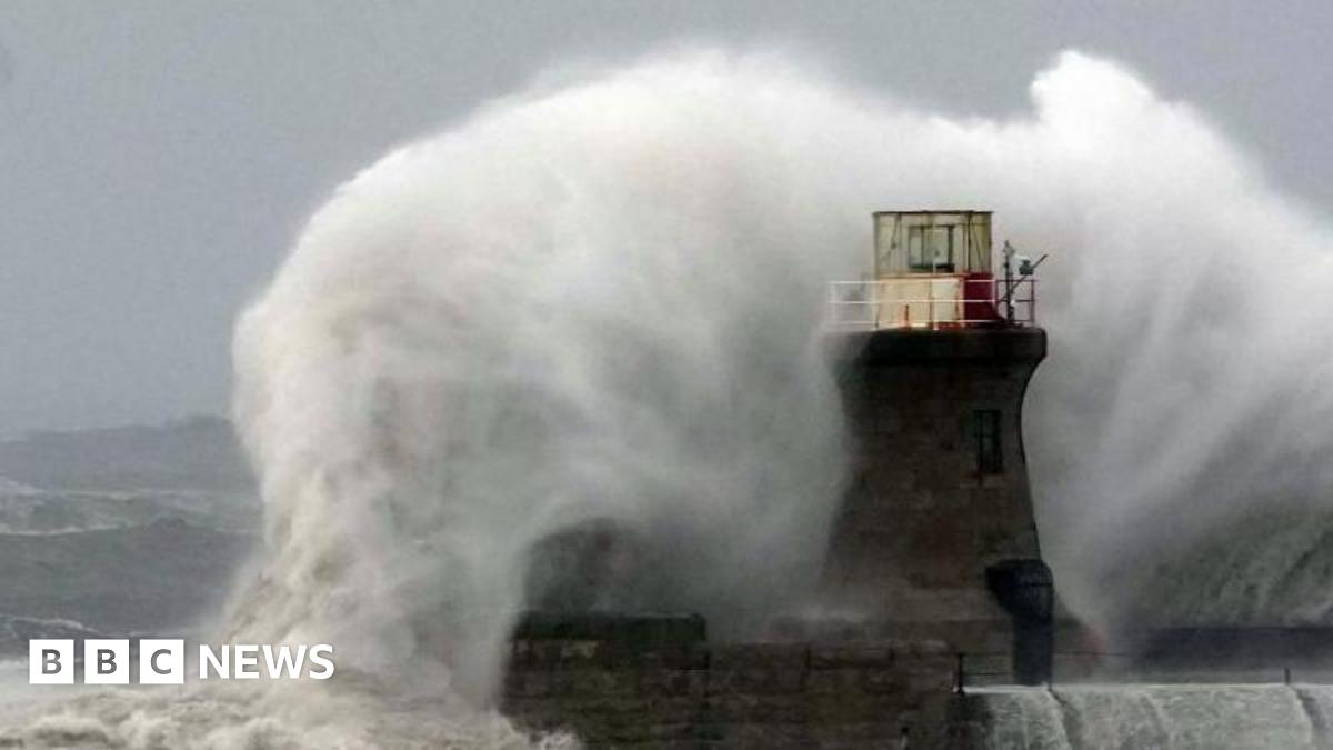 Large wave crashing against a lighthouse