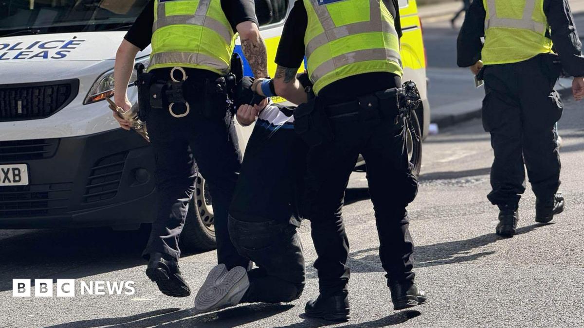 A man being taken away by officers