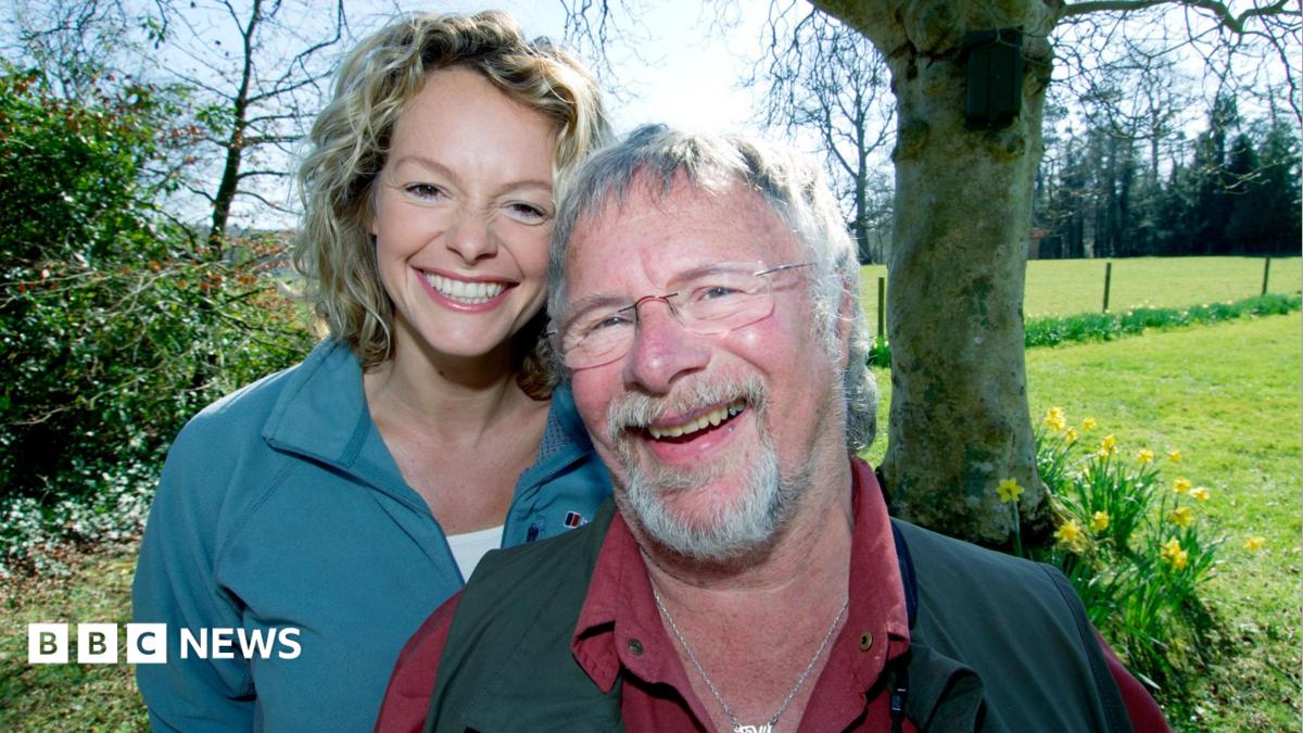 Bill Oddie and Kate Humble standing together and smiling in the countryside
