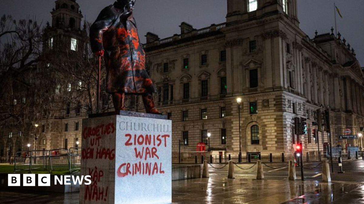 Man arrested on suspicion of racially aggravated criminal damage after Winston Churchill statue in London defaced with graffiti