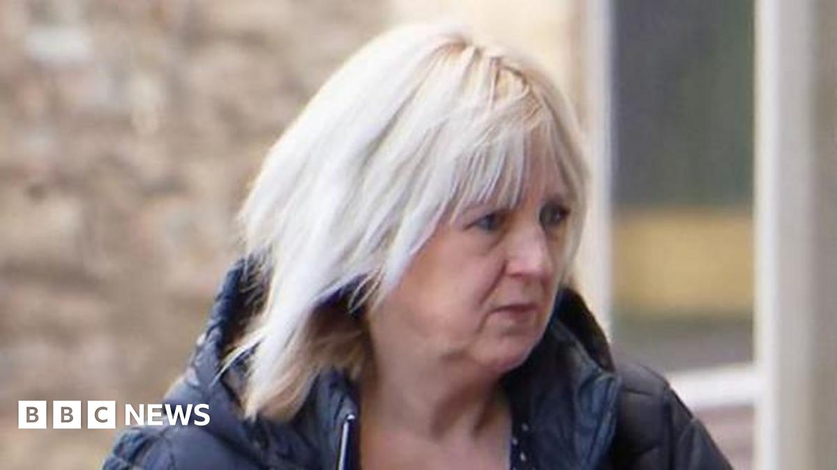 A side shot of Katherine Hill walking into the court. She has blonde hair and a blue puffa coat.
