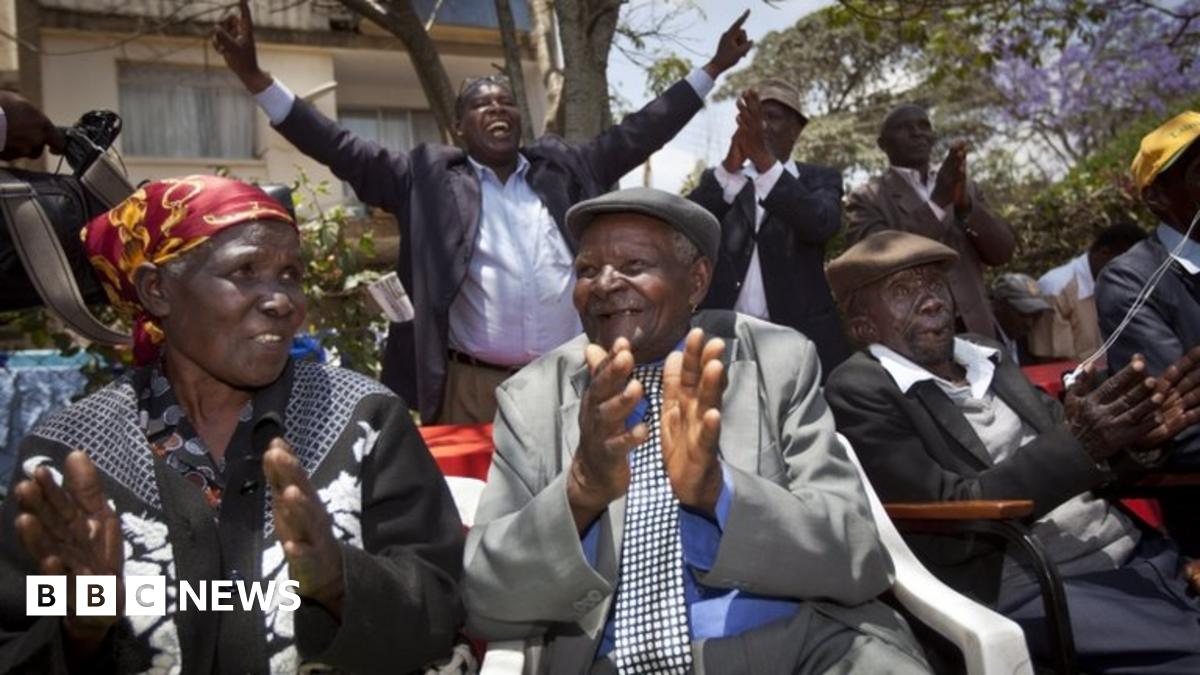 Seated left to right, Kenyans Jane Muthoni Mara, Wambuga Wa Nyingi, and Paulo Muoka Nzili, celebrate the announcement of a legal decision in their case at Britain's High Court concerning Mau Mau veterans, at the offices of the Kenya Human Rights Commis...