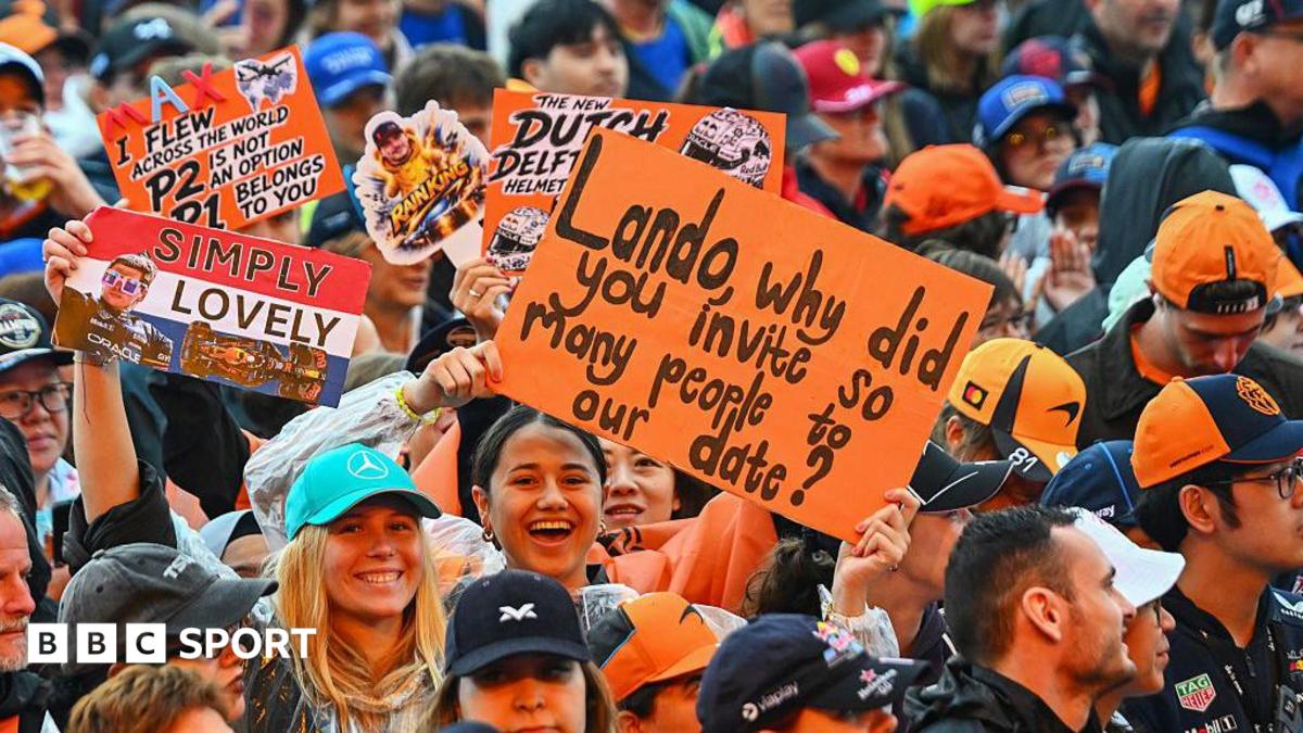 Fans hold up signs in the fan zone in Zandvoort