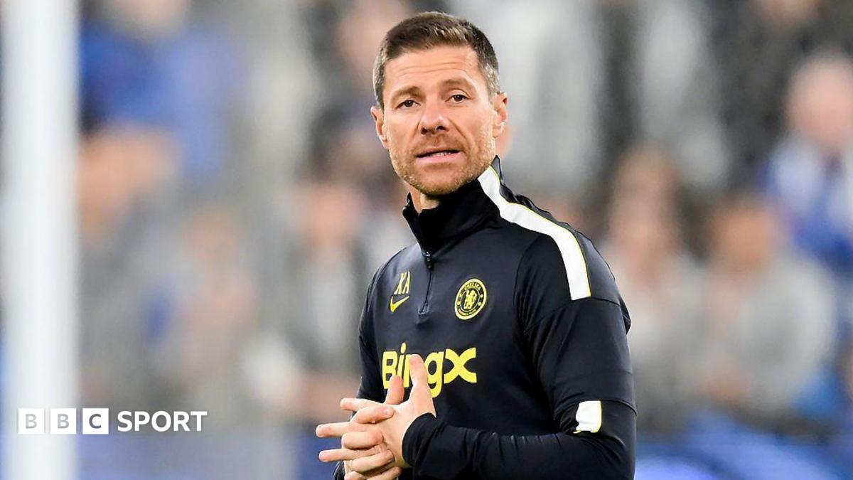 Xabi Alonso clasps his hand together during a Chelsea open training session