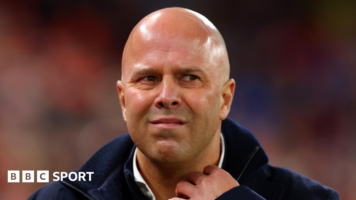 Premier League action with players challenging for the ball under stadium lights