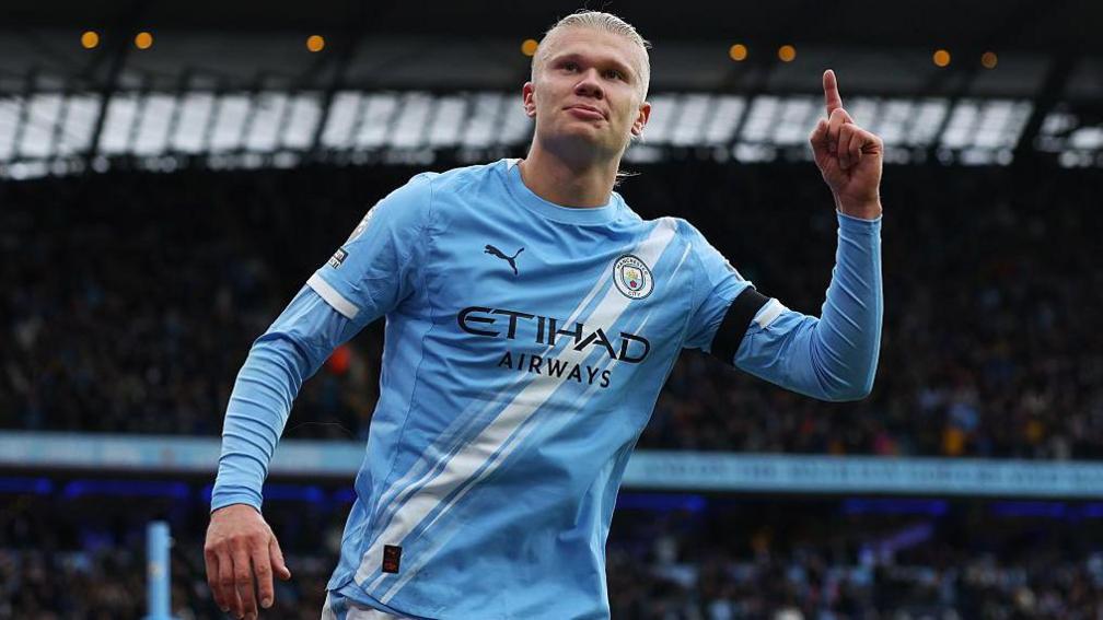 Erling Haaland, pointing with the index finger on his left hand, celebrates another goal for Manchester City