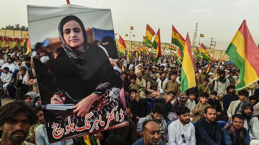 Supporters of Balochistan National Party (BNP) carry posters of arrested Baloch activist Mahrang Baloch during a protest in Quetta on May 2, 2025.