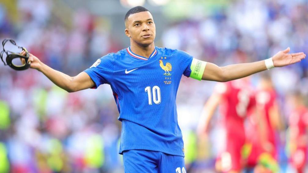 France captain Kylian Mbappe with his arms stretched wide