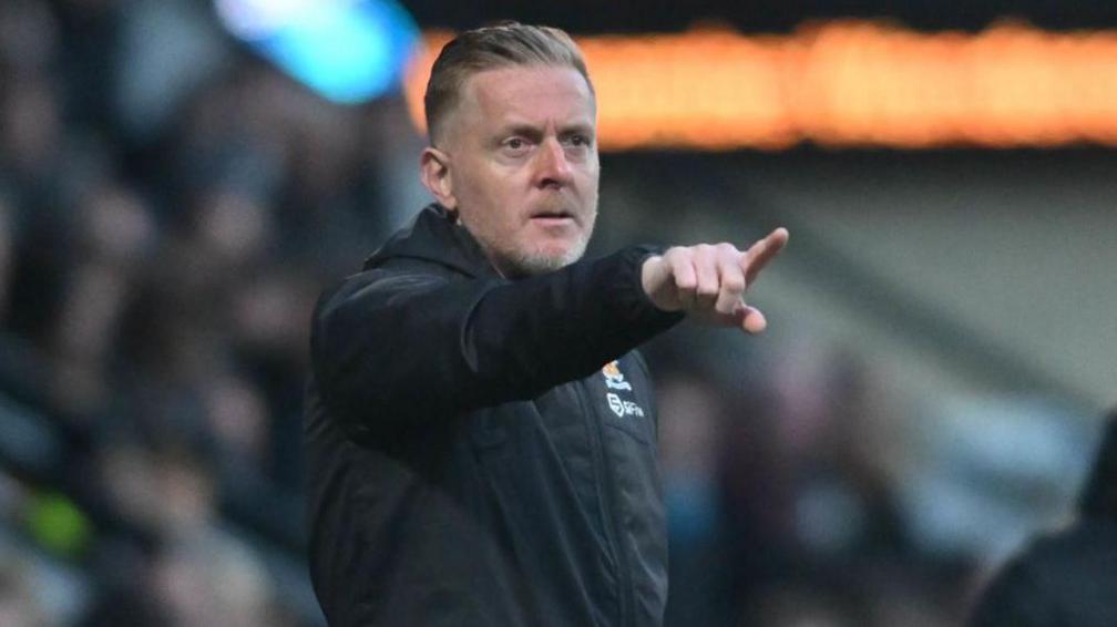 Garry Monk directs his players from the touchline during a game