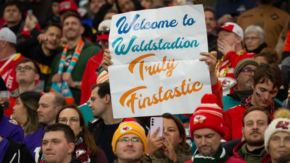 Miami Dolphins fans hold up a sign welcoming the NFL to Frankfurt