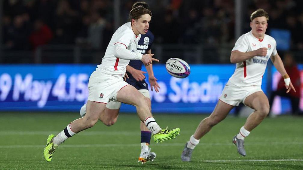 Lucas Friday kicking the ball against Scotland