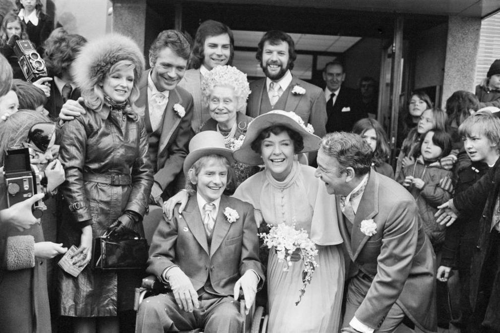 A black and white image of the cast of ATV's Crossroads, in 1975, showing the marriage of character Meg Richardson - played by Noele Gordon and Hugh Mortimer - actor John Bentley. Thousands of fans turned up to attend the ceremony, bringing Birmingham streets to a halt