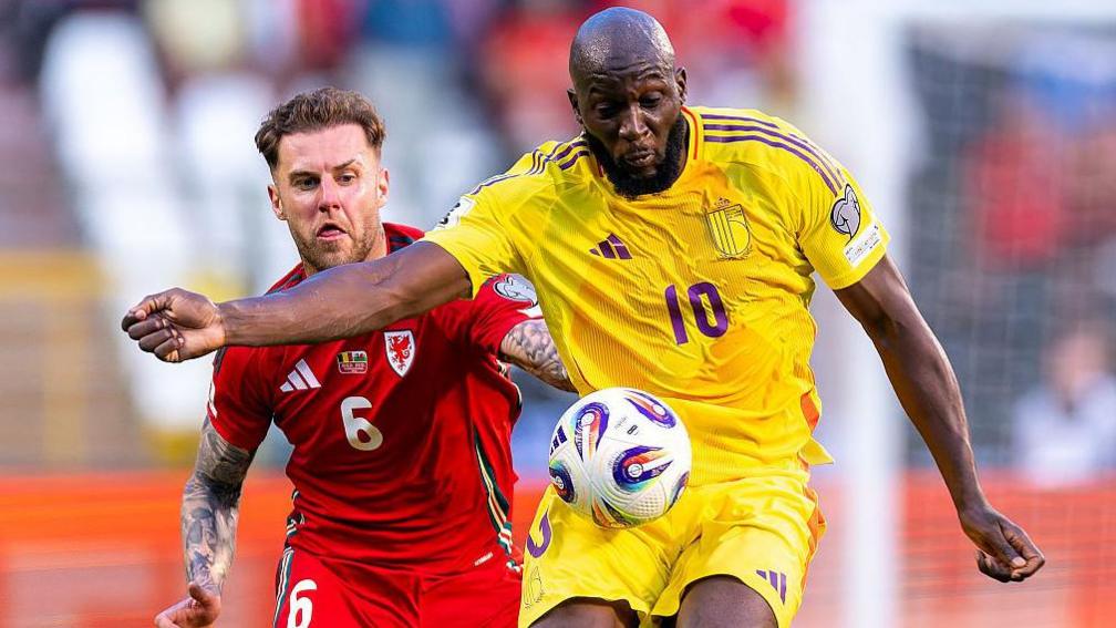 Belgium's Romelu Lukaku holds off Wales' Joe Rodon
