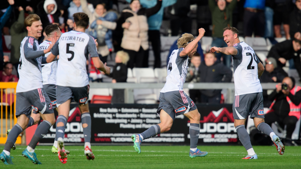 Kevin McDonald (right) celebrates scoring for Exeter City at Lincoln City in League One in October 2025