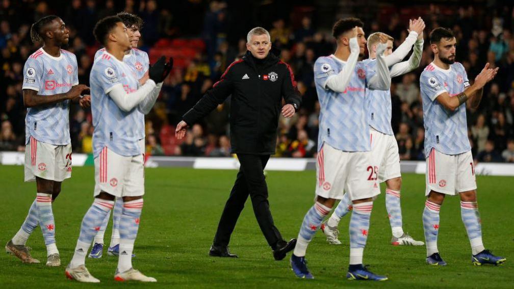 Ole Gunnar Solskjaer walks with his Manchester United players