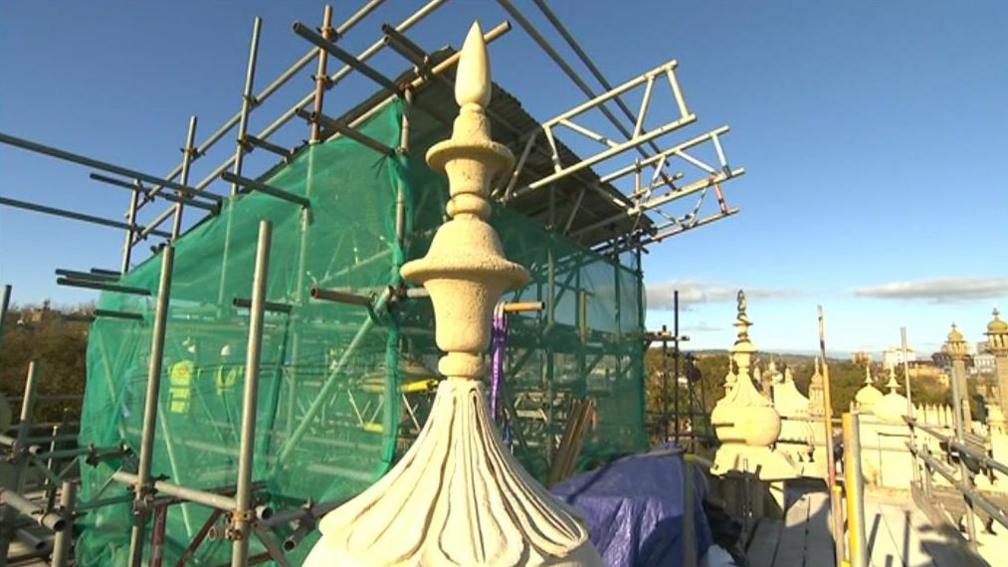 One of the Brighton Pavilion domes with green mesh and scaffolding on it 