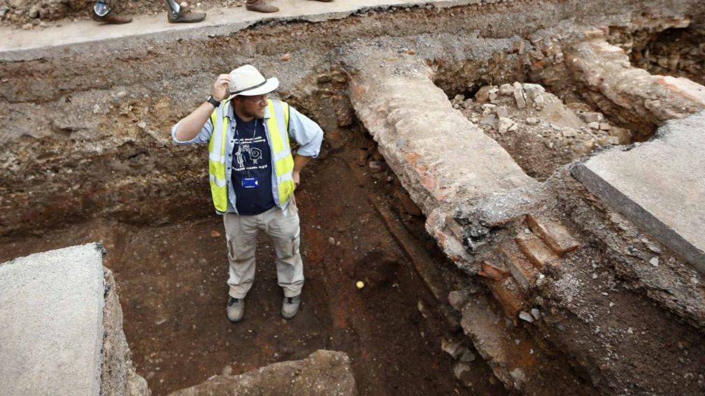 Archaeologist Mathew Morris stands in the trench where he found skeleton remains during an archaeological dig to find the remains of King Richard III in Leicester