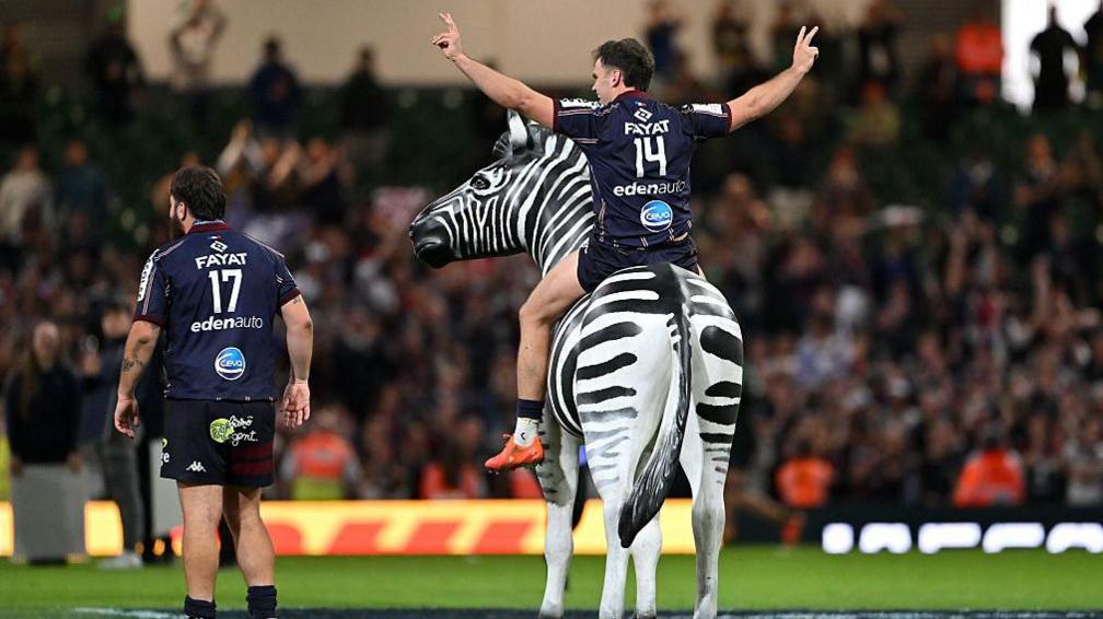Damian Penaud astride a zebra