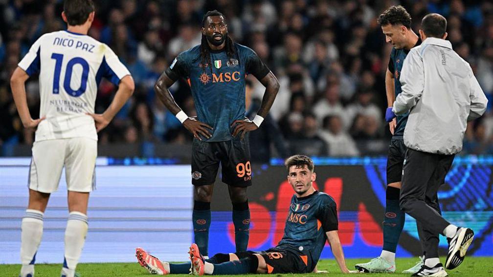 Napoli's Billy Gilmour sits injured against Como