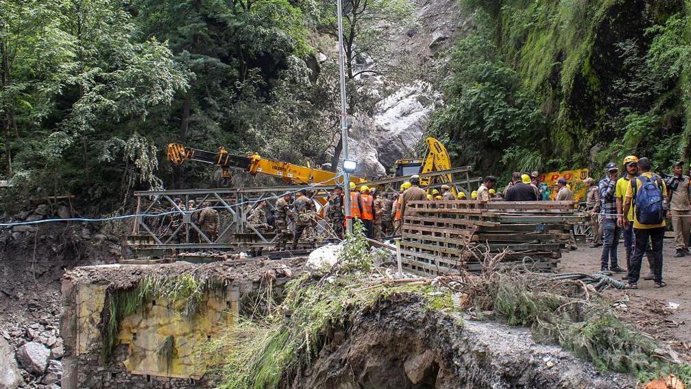 Army and rescue personnel construct a bailey bridge near the Bhatwari village in the Uttarkashi district on August 8, 2025, following a cloudburst that caused a massive mudslide and flash floods in India's Uttarakhand state. Scores of people are missing after water and debris tore down a narrow mountain valley, smashing into the town of Dharali in Uttarakhand state on August 5. At least four people have been confirmed killed, but at least 50 others are missing.