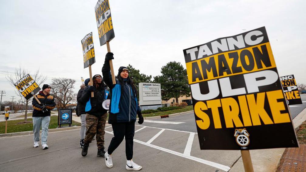 Amazon delivery drivers walk the picket line outside Amazon delivery station as they went on strike in Skokie, Illinois on December 19 2024. 