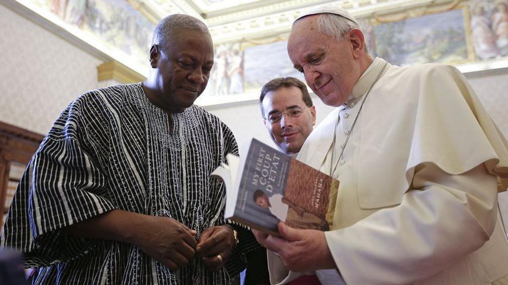 Pope Francis exchanges gifts with President of Ghana John Dramani Mahama during an audience at the Apostolic Palace.