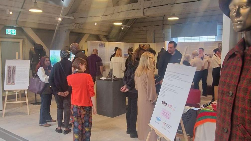 Around 20 people looking at exhibits at Windrush exhibition at Historic Dockyard Chatham 