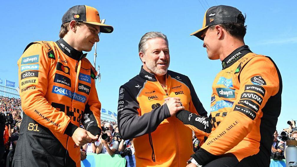 Oscar Piastri, Zak Brown and Lando Norris