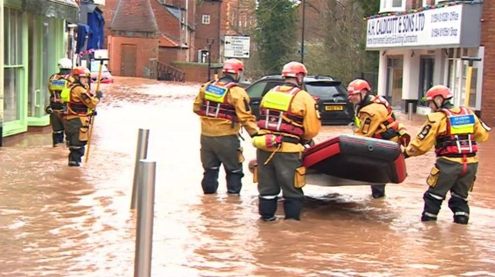 Rescue teams launch a boat on the high street