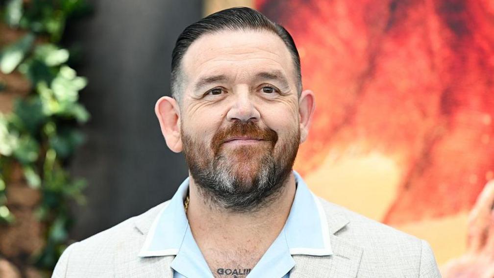 Nick Frost at a film premiere in a grey suit.