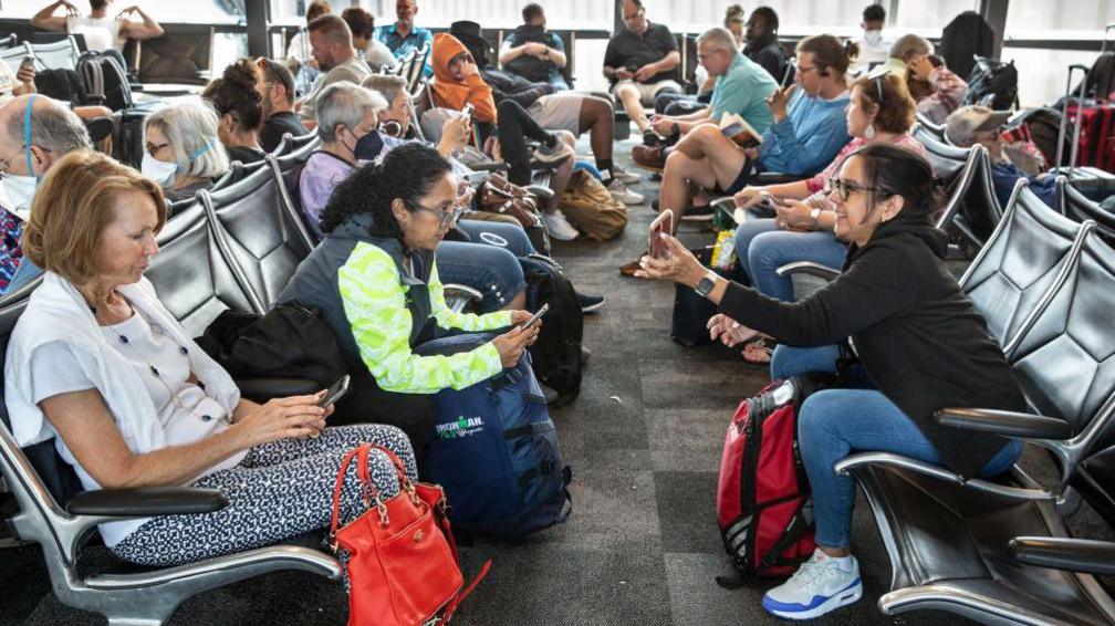 People waiting at a departure gate in Austin, Texas in 2022.