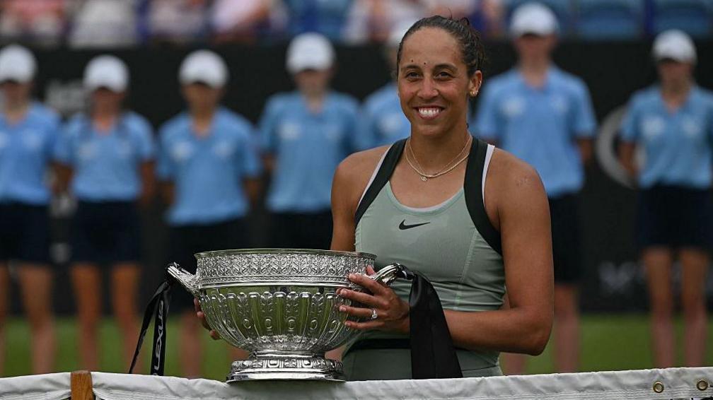 Madison Keys holds Eastbourne trophy at net
