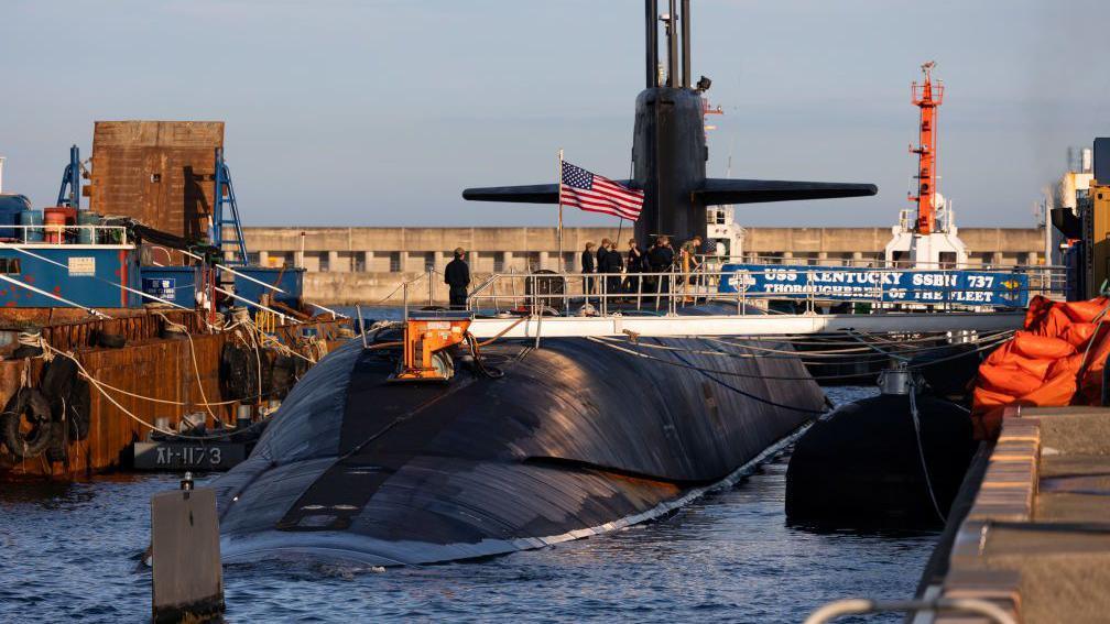 The USS Kentucky ballistic missile submarine on the surface of the water and carrying a US flag, in Busan, South Korea, on 19 July 2023.
