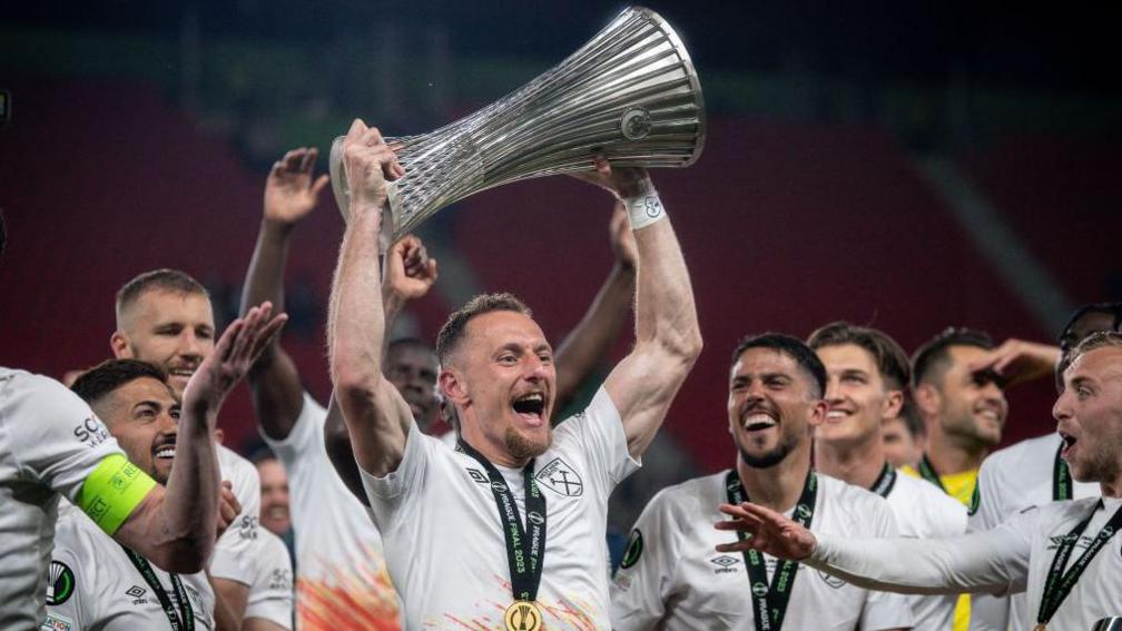 Vladimir Coufal lifts the Europa Conference League trophy
