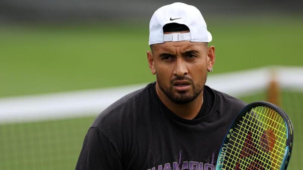 Nick Kyrgios holding a tennis racquet