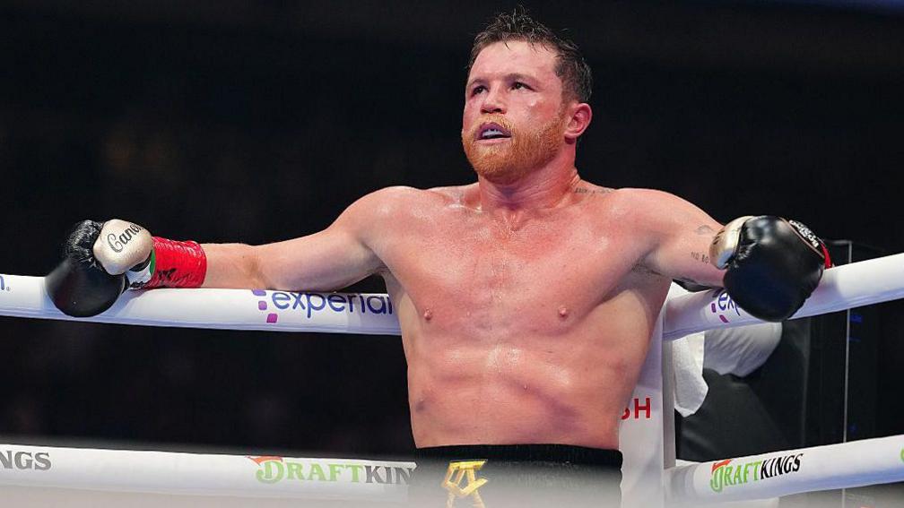Saul Canelo Alvarez leands on the ring during his bout