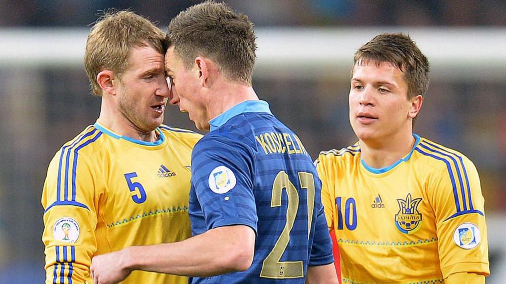 Ukraine's Yevhen Konoplyanka tries to stop an argument between Laurent Koscielny and Oleksandr Kucher before they were both sent off 