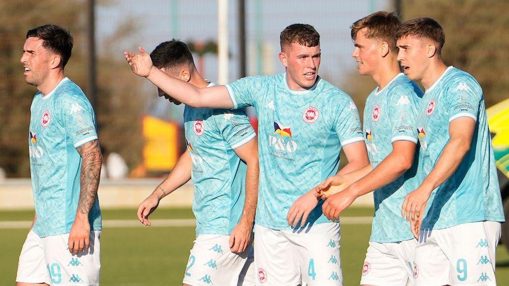 Larne celebrate after scoring for Lincoln Red Imps