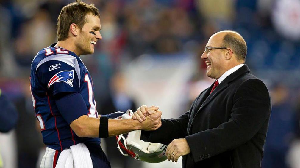 Tom Brady [left] shakes hands with Scott Pioli