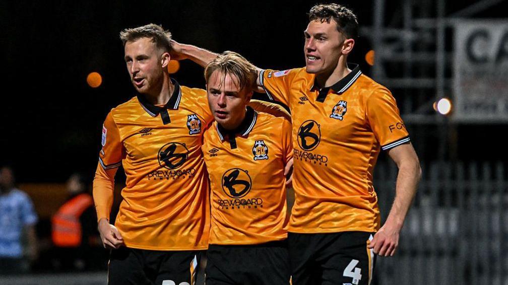 Cambridge United players Ben Stevenson, Liam Bennett and Paul Digby.